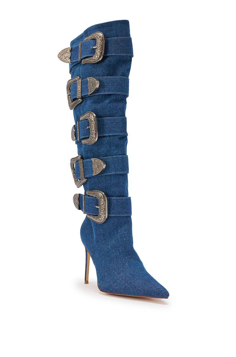 The AKIRA GOLD FALLON DENIM BUCKLE EMBELLISHED STILETO BOOT features a tall, pointed-toe silhouette in blue denim with five large silver buckle straps running up the shaft for bold cowgirl-inspired style. 5