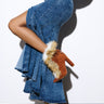 A person wearing a long, flowing layered denim skirt and the FANCY TAN LACE UP CHUNKY BOOTIE WITH FUR stands against a plain background.