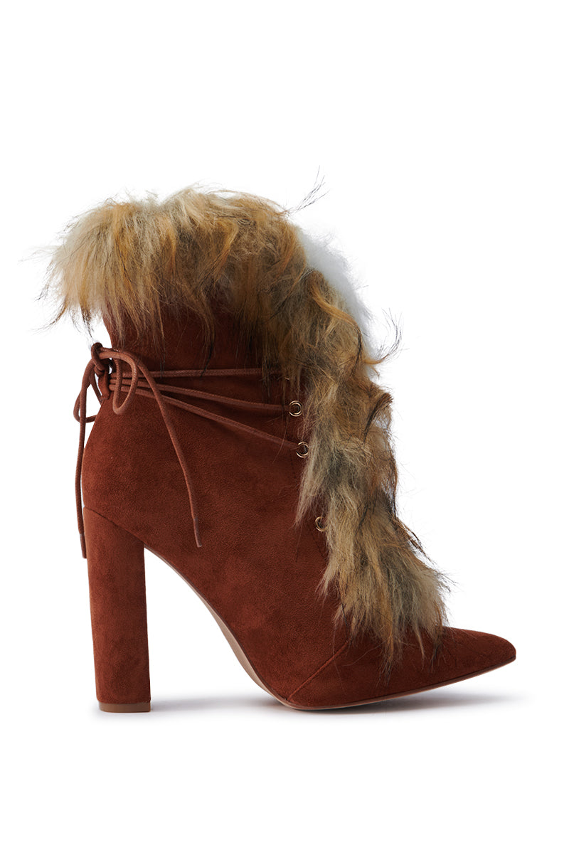 Introducing the Fancy Tan Lace Up Chunky Bootie with Fur, a chic and stylish shoe featuring a faux suede finish. This fashionable bootie showcases a pointed toe and a chunky block heel, adorned with decorative laces and faux fur trim that extends over the top edge for an elegant yet cozy look.