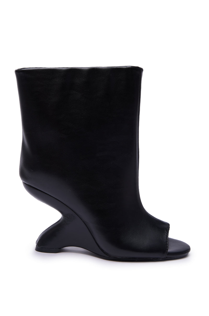The AZALEA WANG FAOI is a black faux leather bootie featuring an inverted wedge and open toe.