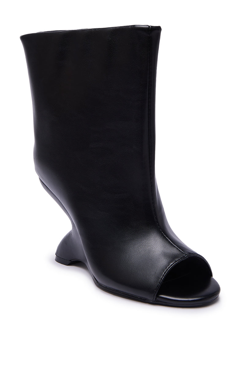 The AZALEA WANG FAOI Black Inverted Wedge Open-Toe Bootie features smooth leather, a unique curved heel, and high-heeled design, shown on a white background.