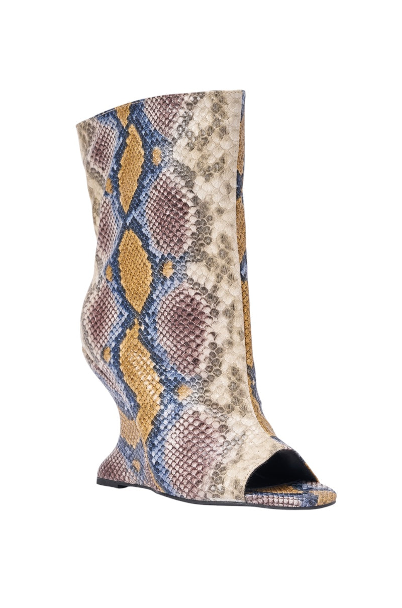The AZALEA WANG FAOI SNAKE MULTI OPEN TOE WEDGE BOOTIE features a blue, yellow, brown, and beige snake print, open toe design, inverted wedge heel, and distinctive sculpted silhouette with textured details. 4