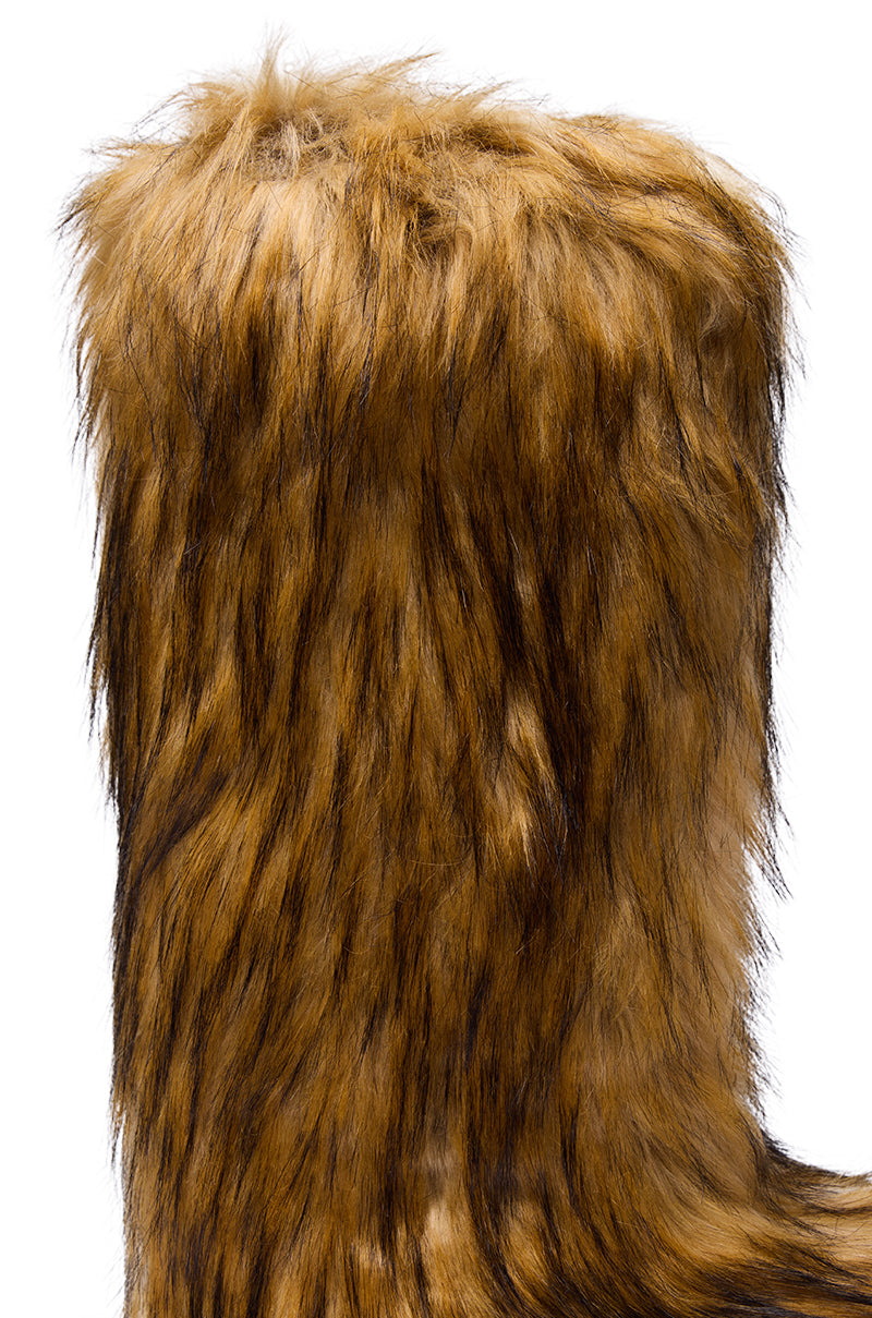 Close-up of the AZALEA WANG FAYES BROWN MULTI FURRY KNEE HIGH FLAT BOOT—tall with long, shaggy brown faux fur and darker streaks, perfect for stylish winter warmth, shown against a white background.