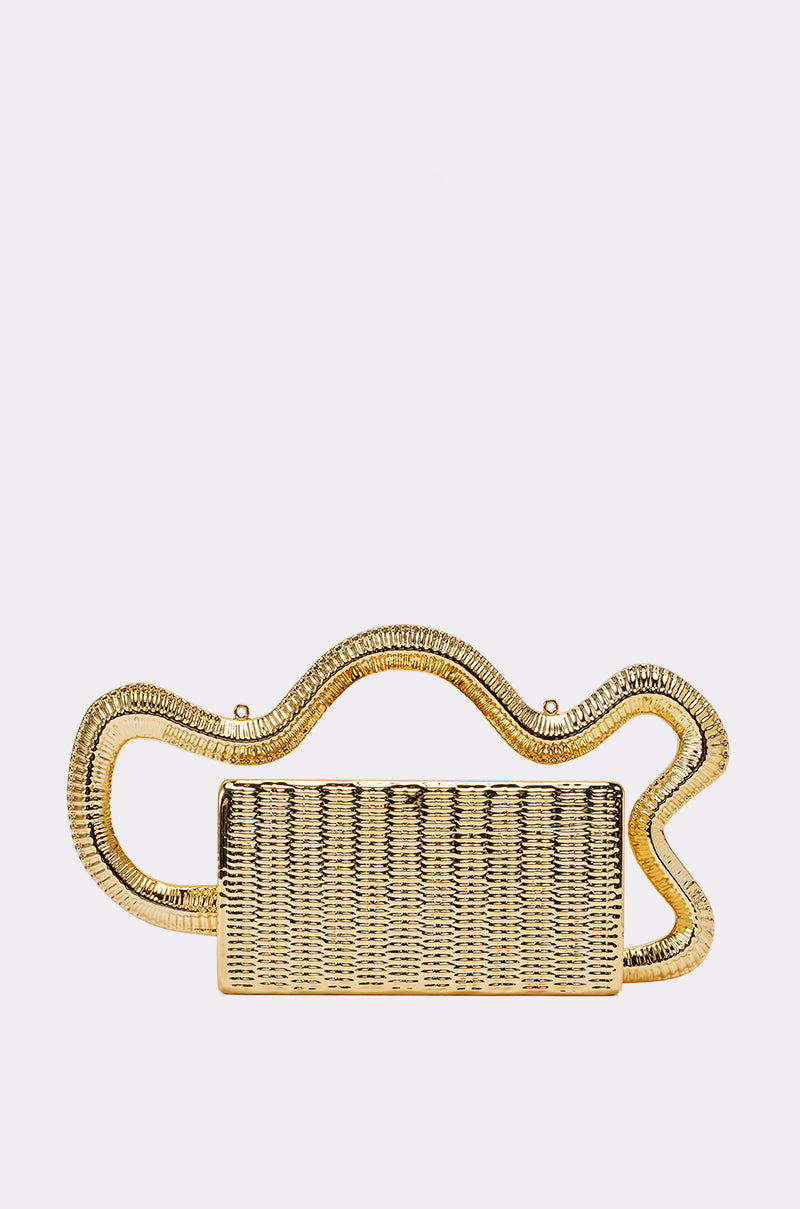 The GOLDEN GIRL BAG is a rectangular gold metallic clutch featuring a wavy, textured gold handle that elegantly frames its top and sides. Displayed against a plain white background, this sophisticated evening bag brings a radiant touch to any ensemble.