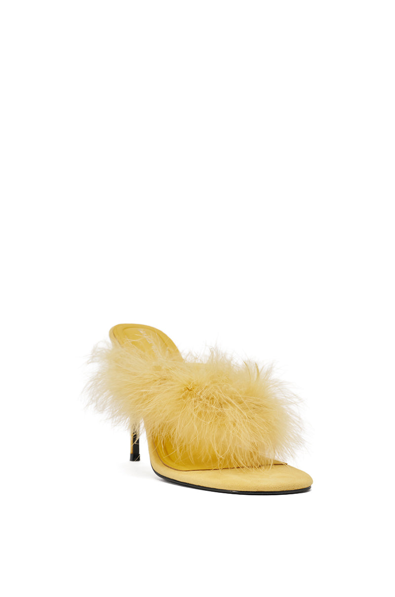 The AKIRA FEMINISTA YELLOW FAUX SUEDE YELLOW FUR EMBELLISHED KITTEN HEEL SANDAL features a fluffy feathered strap and comfort cushion insole, shown against a white background. 4