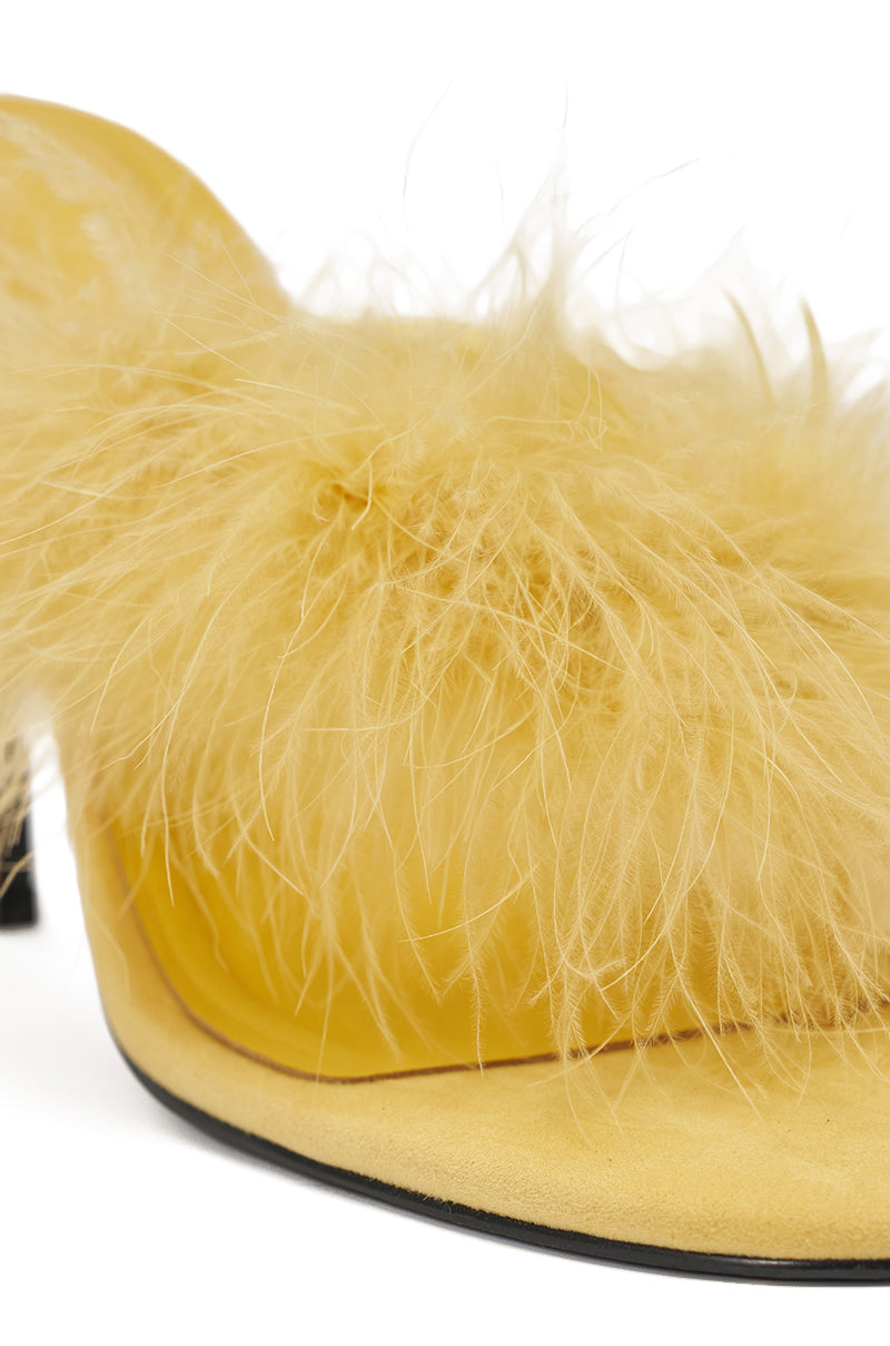 A close-up of the AKIRA FEMINISTA Yellow Faux Suede Kitten Heel Sandal, featuring yellow fur embellishment on the upper, shown against a white background. 6