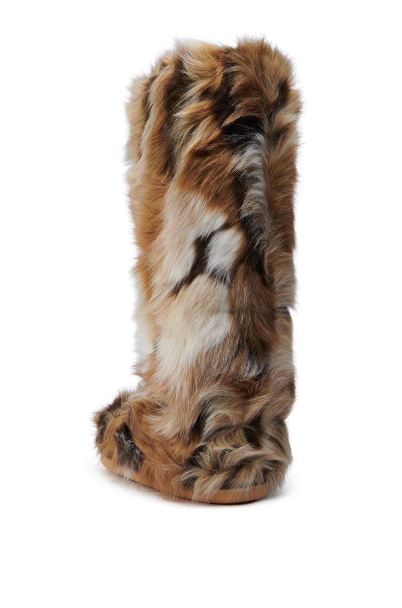The AZALEA WANG FENNEC Multi Fuzzy Flat Knee High Boot stands on a plain white background, featuring a blend of tan, white, and dark brown faux fur. The shaggy fur extends beyond the edges for a delightful fuzzy appearance. This stylish boot is designed with a flat sole for comfortable wear.