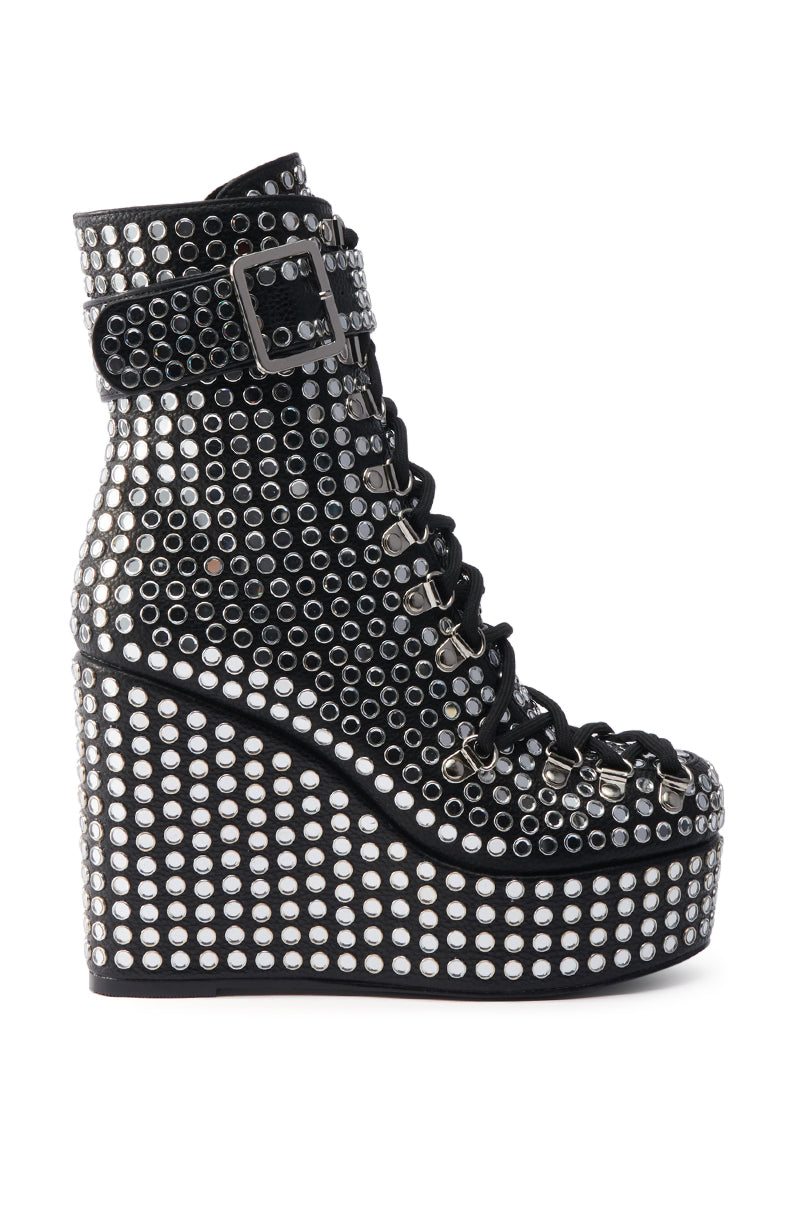 The AZALEA WANG FERDY BLACK PLATFORM EMBELLISHED BOOTIE features silver studs, black laces, and an ankle buckle strap on a bold wedge heel—perfect for making a statement.
