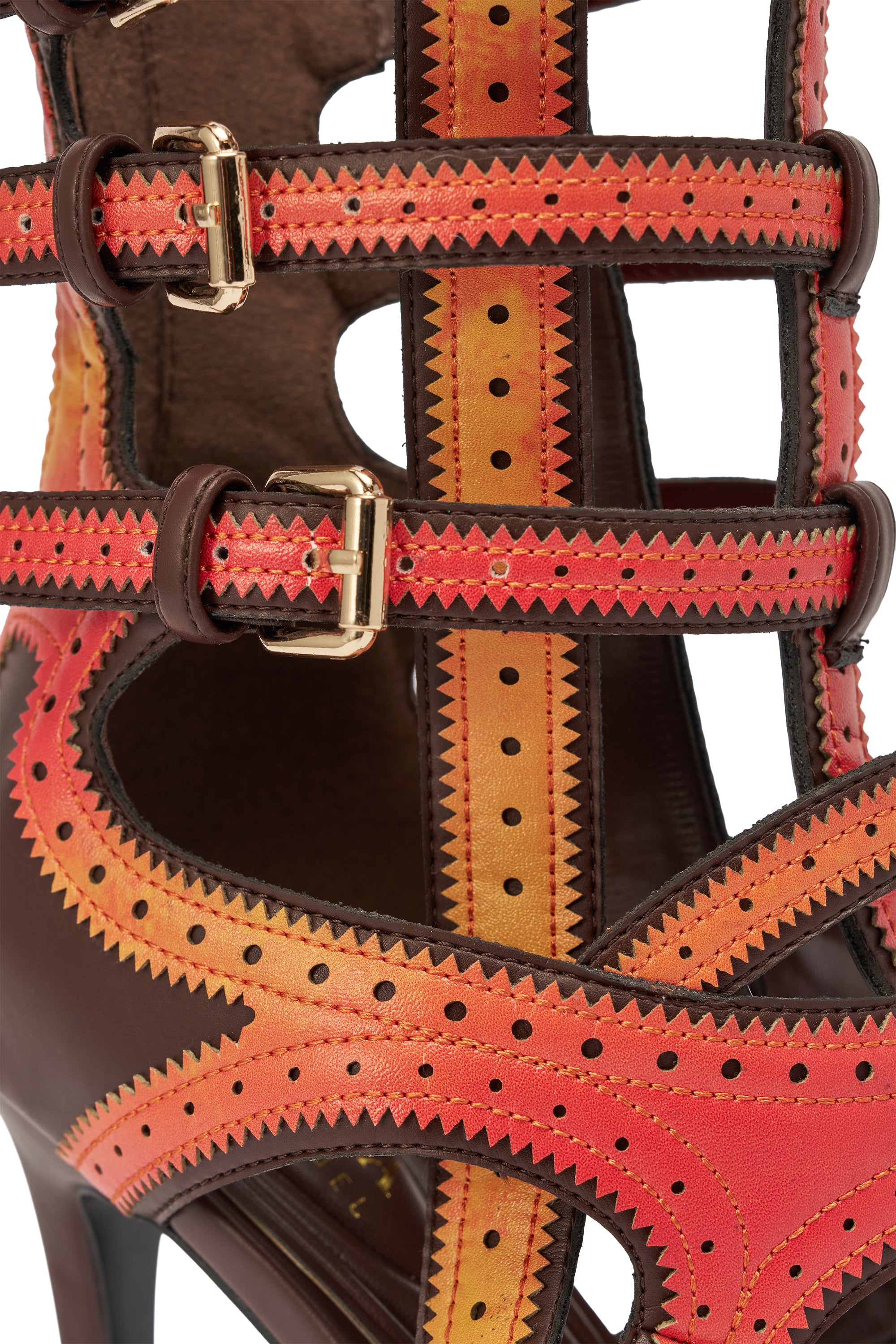 Close-up of the AKIRA GOLD FEVER ORANGE MULTI OMBRE OPEN TOE BOOTIE: an orange stiletto bootie with brown leather, colorful red, orange, and yellow straps, zigzag edges, perforated details, and gold buckles. 9