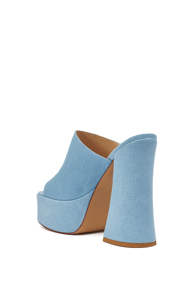 The AKIRA GOLD FIKILE DENIM CHUNKY SANDAL is a light blue denim platform sandal with a chunky block heel and open back, shown at an angle on a white background. 6