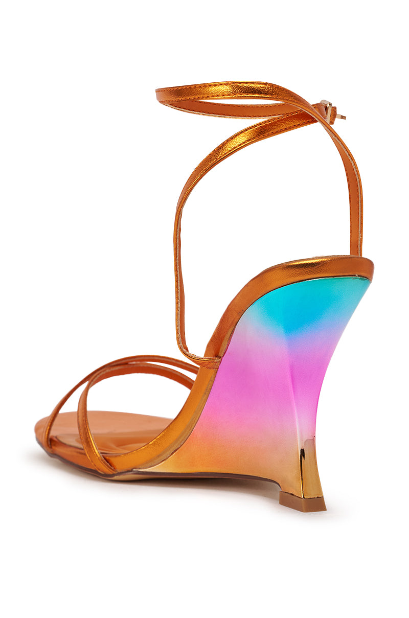 The AKIRA GOLD FINGA CHROME WEDGE STRAP SANDAL features a metallic orange finish, comfort cushion insole, strappy ankle buckle design, and a rainbow ombre wedge blending blue, pink, and yellow for vibrant style. 6