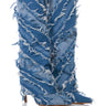 The AZALEA WANG FISHER DENIM STILETTO BOOT boasts a distinctive shredded and distressed design pattern across its knee-high denim exterior. With a pointed toe and high heel, these boots truly stand out against the white background.