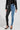 A person wears distinctive FLEX FIT EXTREME STRETCH HALF AND HALF PU HIGH WAIST SKINNY JEAN featuring black faux leather on one leg and blue denim on the other. They are also wearing a black leather jacket, with their hands by their sides, and studded black high heels.