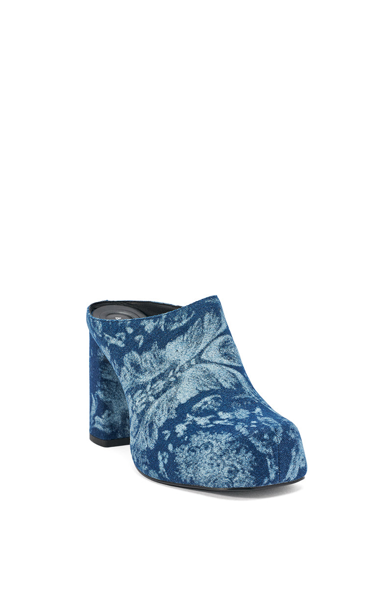 The AZALEA WANG FLOREA DENIM PRINT MULE is a blue slip-on mule with a chunky heel, accented by a textured floral pattern in lighter blue shades. 5