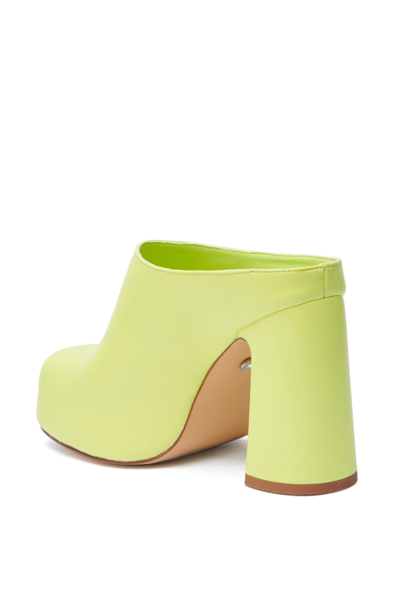 The AZALEA WANG FLOREA LIME CLOG STYLE PUMP is a faux leather mule in lime green with a chunky round heel and closed toe, displayed from a rear side angle against a white background.