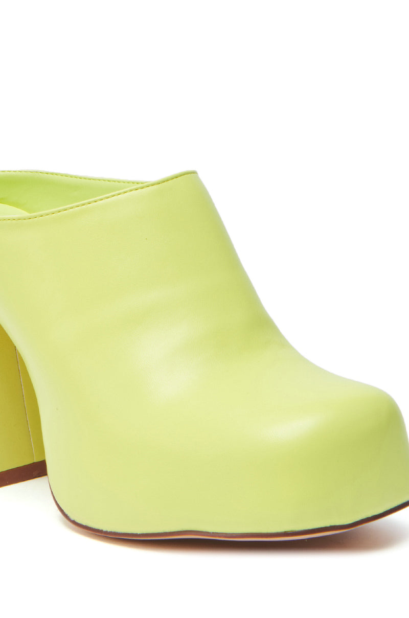 A close-up of the AZALEA WANG FLOREA LIME CLOG STYLE PUMP shows its chunky faux leather design, rounded toe, thick heel, and brown sole.