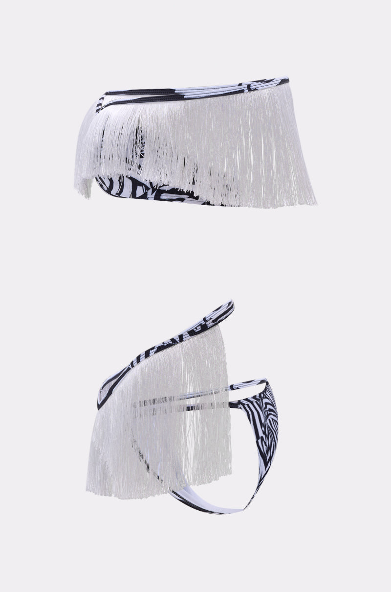 The TOO WILD FOR YOU BIKINI is a two-piece set with a bold zebra print and striking white fringe trim on the top and bottoms, showcased against a simple light background.