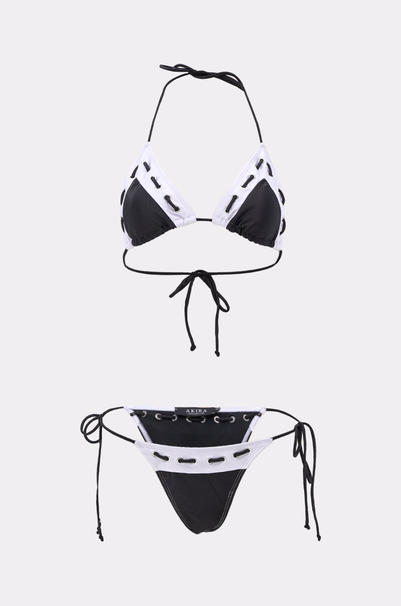 The SPORTY VIBES SWIMSUIT is a black bikini set with metallic trim, featuring a triangle top with halter and back ties, plus matching bottoms with side ties and lace-up accents, displayed on a plain white background. 0