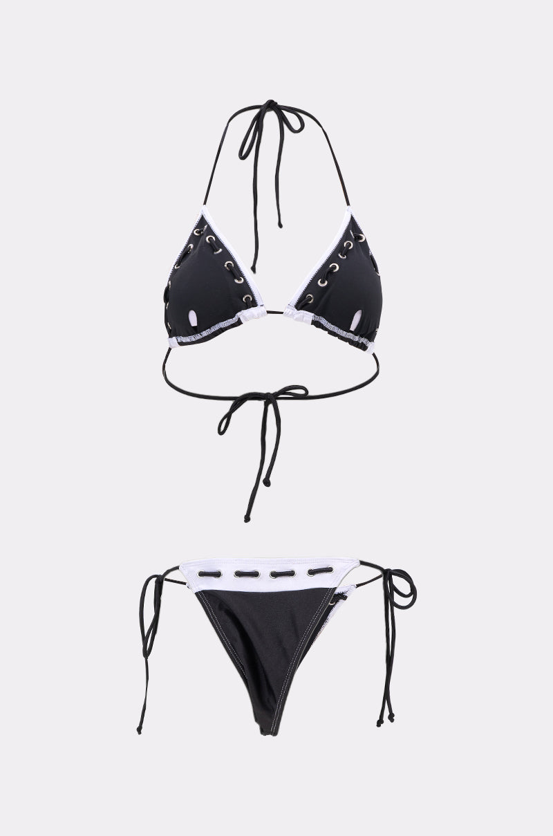 The SPORTY VIBES SWIMSUIT is a black bikini with metallic trim and lace-up details, featuring a halter neck tie-back top and string bikini bottoms with adjustable side ties, displayed on a plain white background. 2