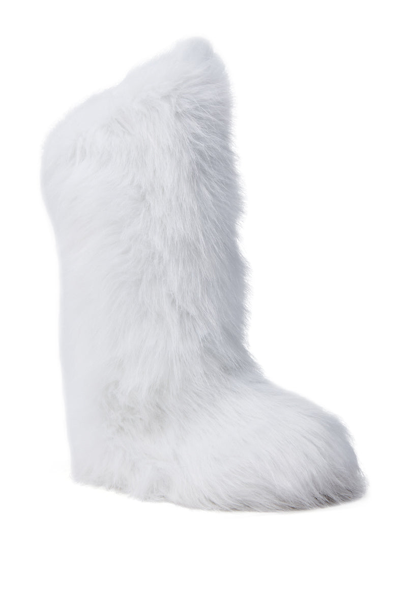 The FONDA WHITE FLAT BOOT is a single, white, fluffy boot with faux fur covering its entire surface, set against a plain white background. This winter-ready boot boasts a simple, rounded design and looks soft and warm.