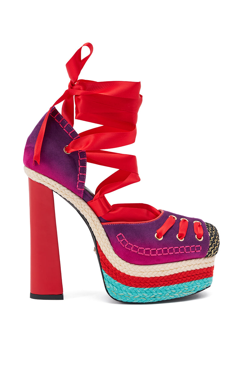 The AKIRA GOLD FONTEYN RED MULTI CHUNKY PLATFORM LACE UP PUMP features a bold red heel, purple and pink upper, turquoise sole, and red ribbon ankle laces with colorful stitching and woven retro-inspired details. 3
