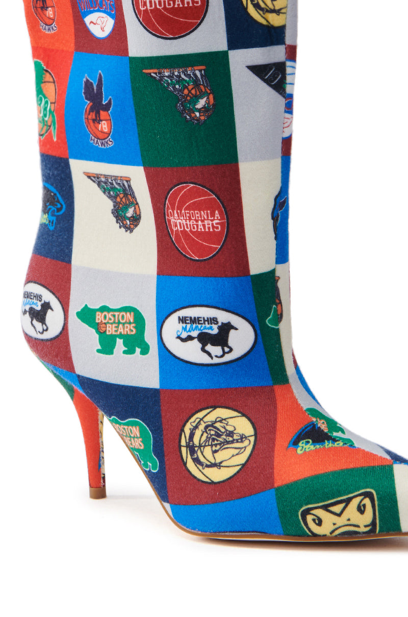 A close-up of the AZALEA WANG FOUL MULTI SPORTY BOOTIE highlights its vibrant, sporty-chic patchwork design with team logos like Boston Bears and California Cougars, featuring a striking colorblock pattern in red, blue, green, and white squares.