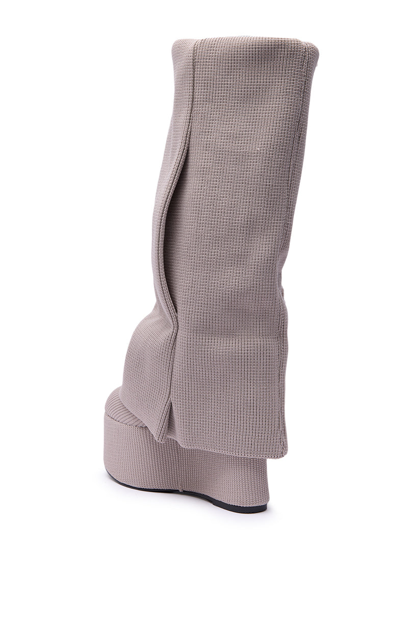 The AZALEA WANG FRANKEYE BEIGE FLATFORM BOOT is a tall, light beige knee-high style with a textured fabric surface and bold, unconventional folds along the shaft, shown from the back on a white background.