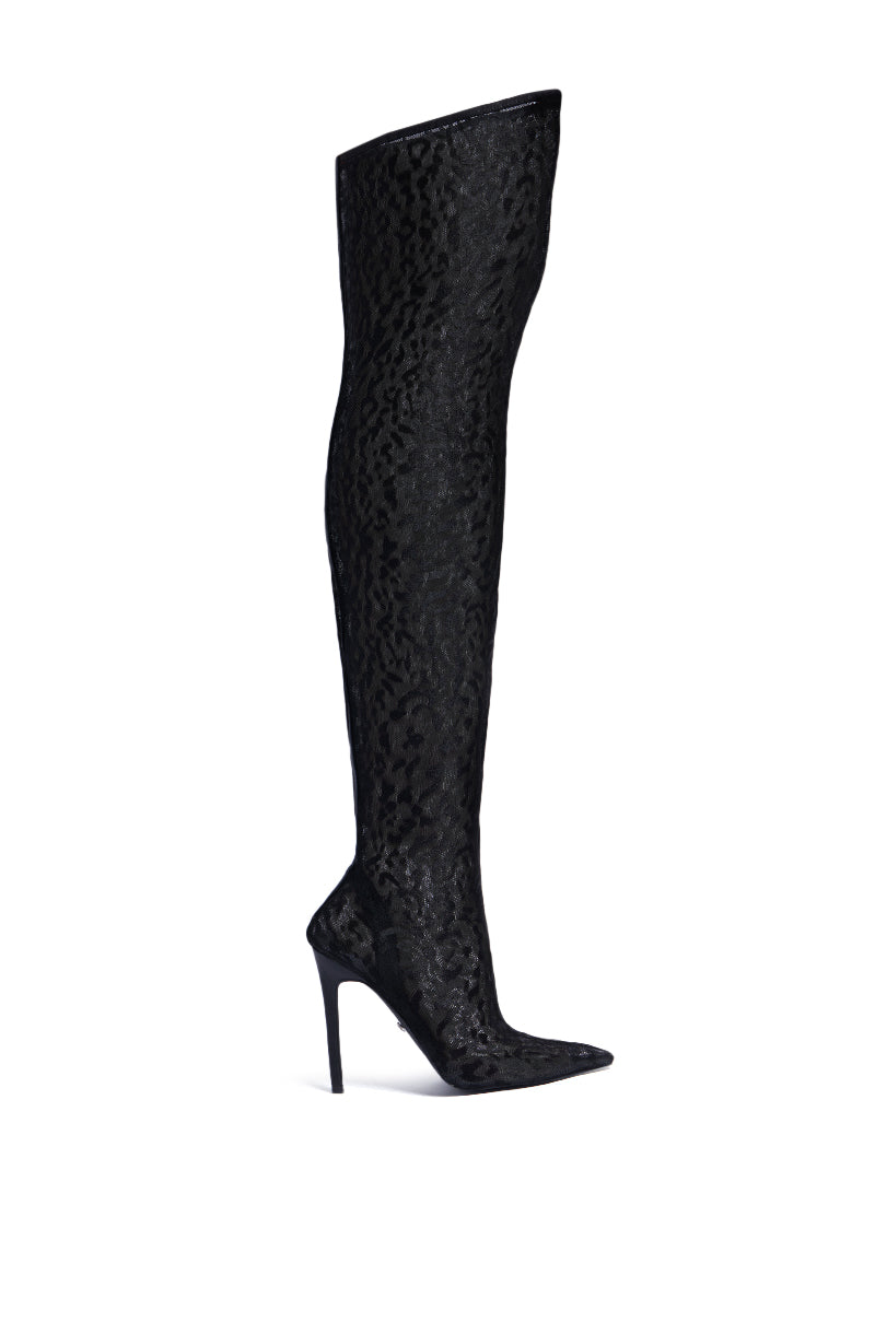 The AZALEA WANG FREYJA OVER THE KNEE LACE BOOT IN BLACK is a single, elegant thigh-high boot with a pointed toe and a slim stiletto heel. This sexy over the knee boot features an intricate, textured pattern, adding a sophisticated and stylish touch.