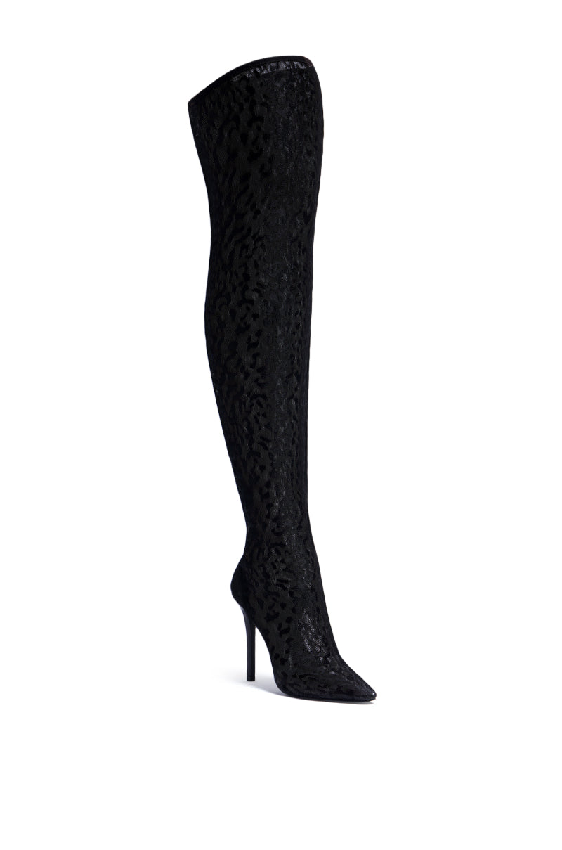 The AZALEA WANG FREYJA OVER THE KNEE LACE BOOT IN BLACK, featuring a textured leopard-print pattern, a pointed toe, and a stiletto heel, is displayed against a white background—a sexy thigh-high boot for those who want to make a statement.