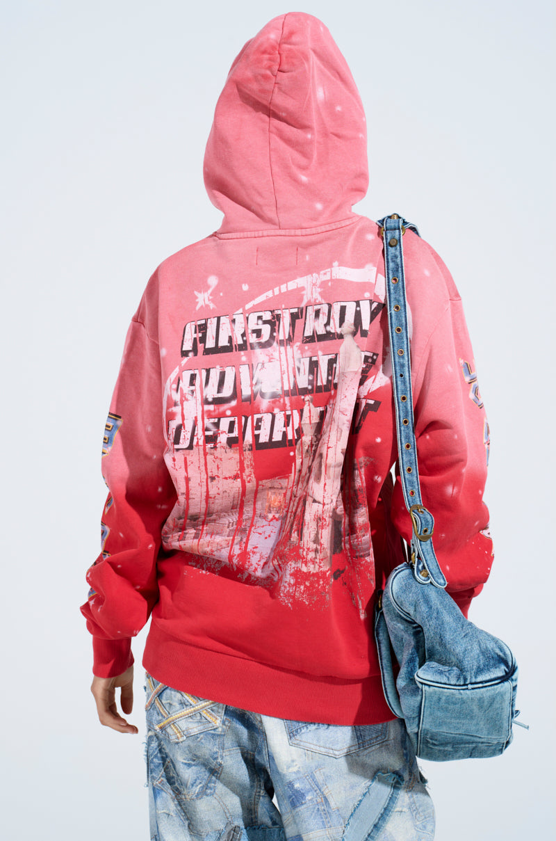 A person in an IN THE FAST LANE HOODED SWEATSHIRT with ombre red-washed, racing-inspired graphics stands facing away, carrying a denim bag and wearing light blue washed-look jeans against a plain white backdrop.