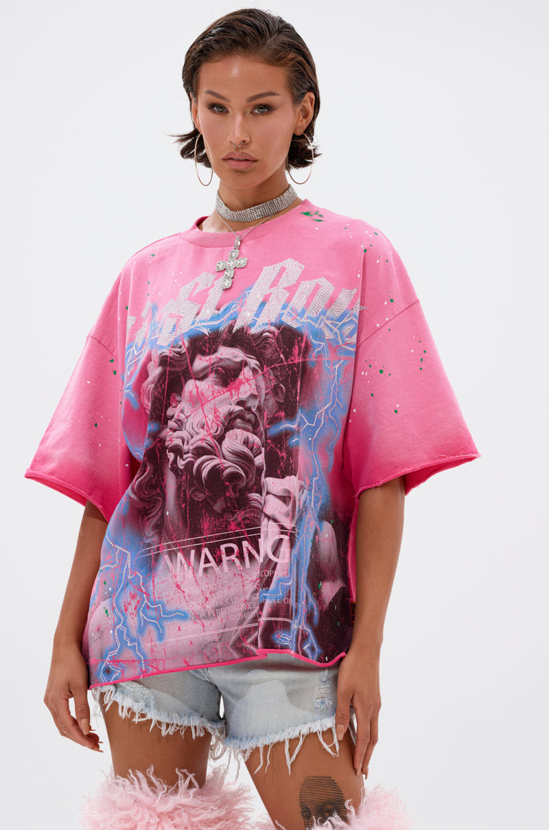 Wearing the bold FADE INTO BLACK OVERSIZED TEE with electric blue and white "WARNING" graphics, light denim shorts, and furry pink boots, a person poses confidently against a plain background.