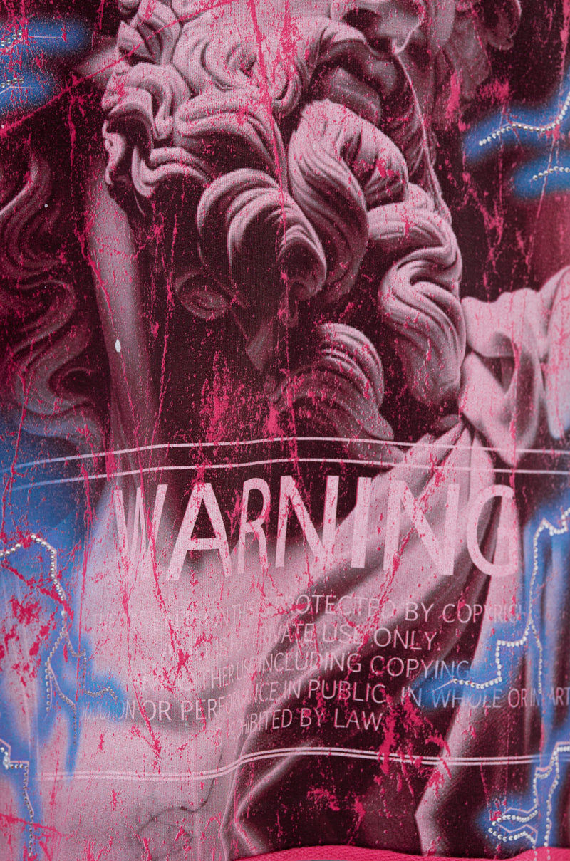 The FADE INTO BLACK OVERSIZED TEE features a digitally altered classical statue with pink and blue paint splatters, bold "WARNING" text, and faint white copyright marks—a standout graphic design for streetwear.