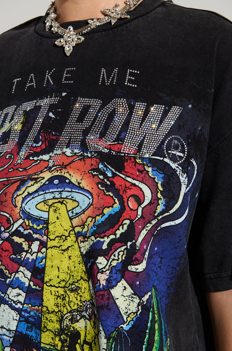 Close-up of someone wearing the FIRST ROW MIDNIGHT RHINESTONE EMBELLISHED T-SHIRT. This black tee features rhinestone "TAKE ME" over a UFO design, complemented by a sparkly floral necklace for added flair.