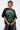A person with short, slicked-back hair wears the PROPERTY OVERSIZED GRAPHIC TEE in black, featuring a green graphic and 