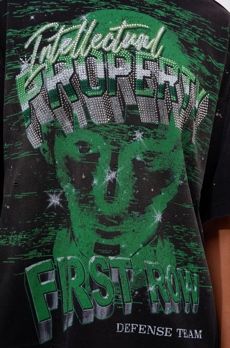 A close-up of the PROPERTY OVERSIZED GRAPHIC TEE: a black cotton graphic tee with a green pixelated face and bold, stylized words—"Intellectual Property," "First Row," and "Defense Team.