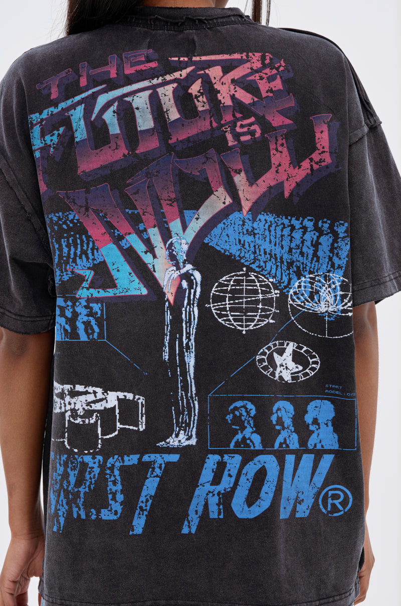 Someone wears the OUT OF BODY OVERSIZED GRAPHIC TEE, a unisex streetwear piece featuring bold, colorful futuristic graphics, abstract figures, geometric shapes, and “THE FUTURE IS NOW” and “FIRST ROW” on the back. 6