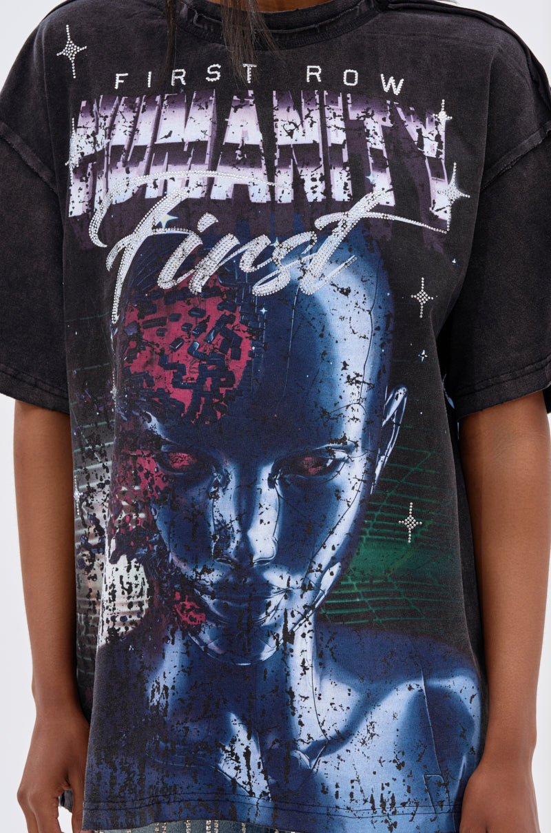 Someone wears the OUT OF BODY OVERSIZED GRAPHIC TEE, a unisex streetwear shirt with a futuristic blue humanoid face, red circuitry and glitch effects, plus bold distressed "First Row" and "HUMANITY First" text. 7