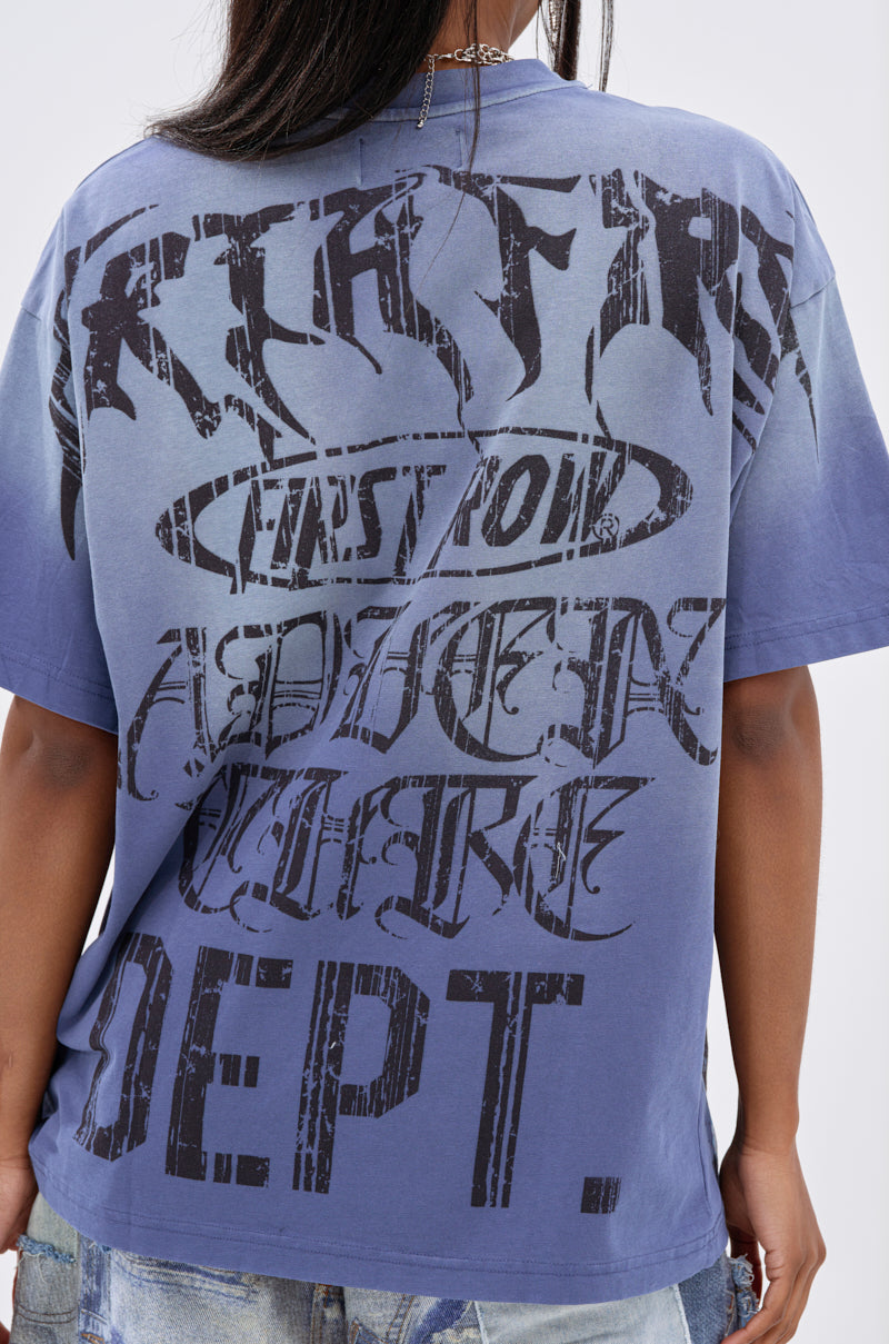 A person is shown from behind wearing the IRREVERENT OVERSIZED GRAPHIC TEE, which features large, bold black text in various fonts across the back, paired with light-wash jeans.