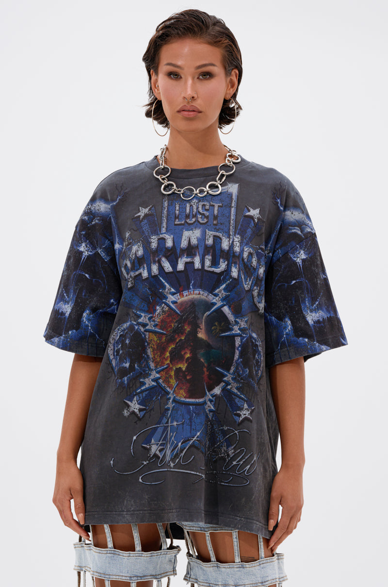 A person with short, wet-look hair wears a chunky silver chain necklace and the INSANE OVERSIZED TEE featuring a dramatic cosmic "Lost Paradise" design, effortlessly paired with distressed cotton pants.