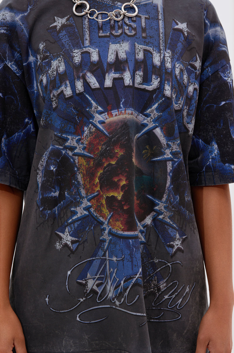 Someone wears the INSANE OVERSIZED TEE, a dark, distressed cotton shirt with "LOST PARADISE," "First Law," cracked earth graphics with electric blue details, paired with a chunky chain necklace.