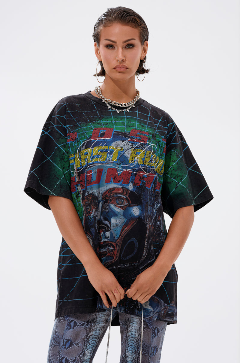 A person with wet, slicked-back hair wears a chunky chain necklace, patterned pants, and the METAVERSE OVERSIZED GRAPHIC TEE featuring abstract designs and text, embracing vintage streetwear on a plain white background.