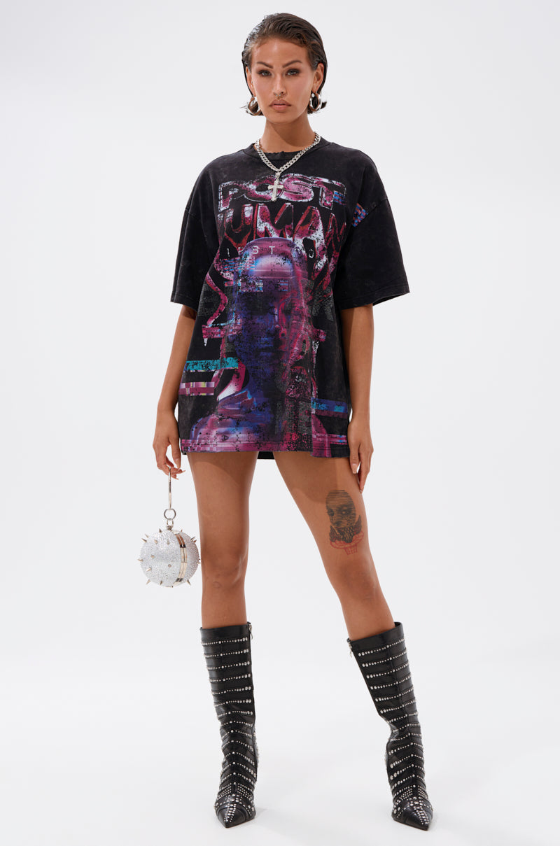 Against a white background, a woman with wet-look hair and a thigh tattoo wears the FIRST ROW CYBERTRONICS OVERSIZED GRAPHIC TEE with black studded knee-high boots and holds a round white studded handbag, channeling futuristic streetwear vibes. 5