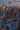 Close-up of a textured artwork featuring a blue robotic face with metallic details, orange cursive text, and shiny beads—ideal for the POST HUMAN OVERSIZED GRAPHIC TEE or any bold cyberpunk streetwear look.