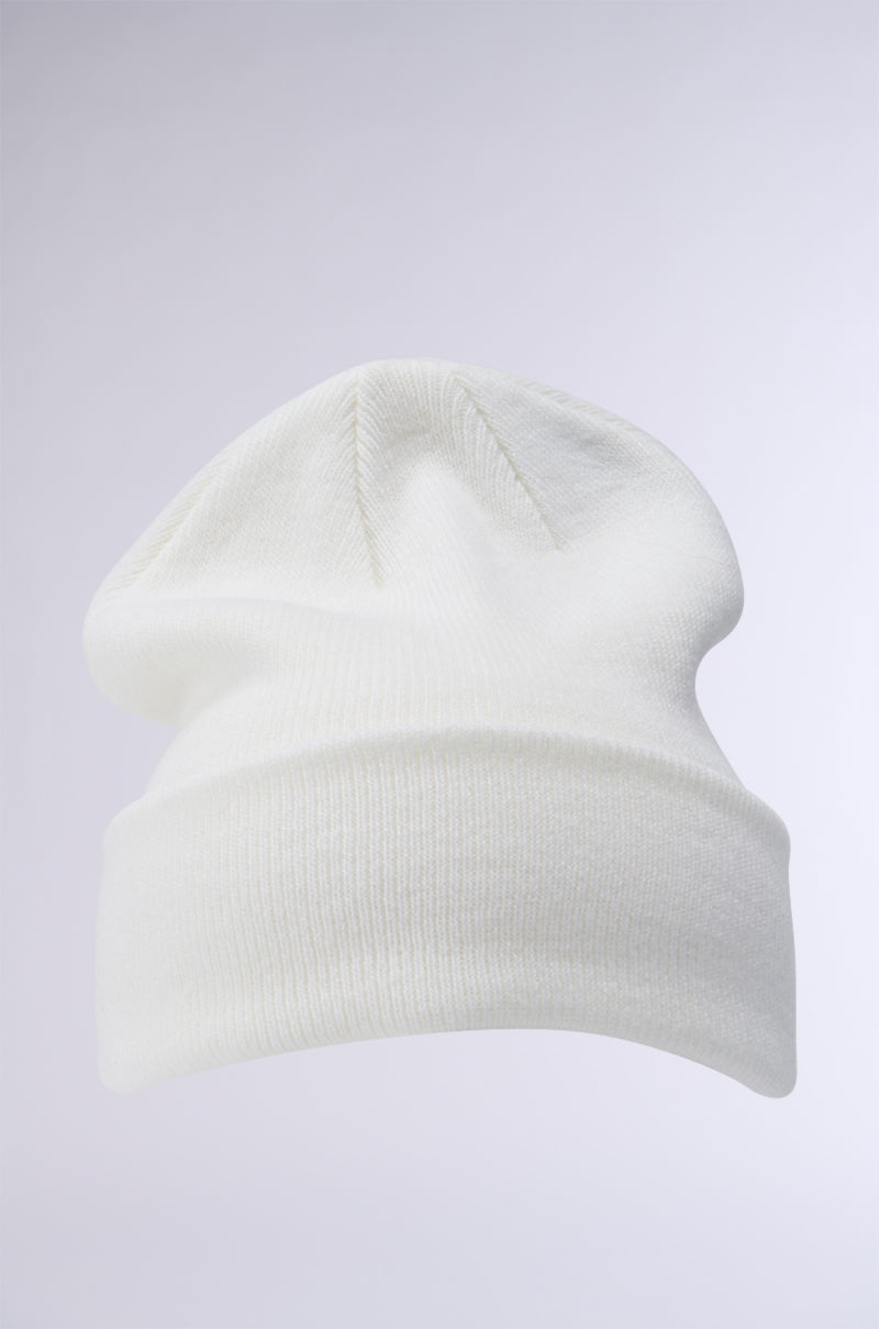 The WINTER WHITE CLASSIC BEANIE with a fold-over brim is displayed on a light grey background, showcasing its seamless design and the soft, cozy texture of its stretch knit fabrication.