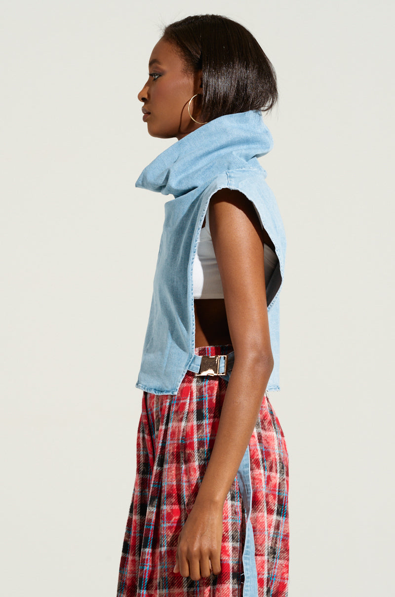 A person is standing in profile against a plain background. They are wearing the MY BEST SELF Sleeveless Statement Top with a large collar and a red plaid skirt. They have straight, shoulder-length hair and are accessorized with hoop earrings featuring adjustable side buckle closures.