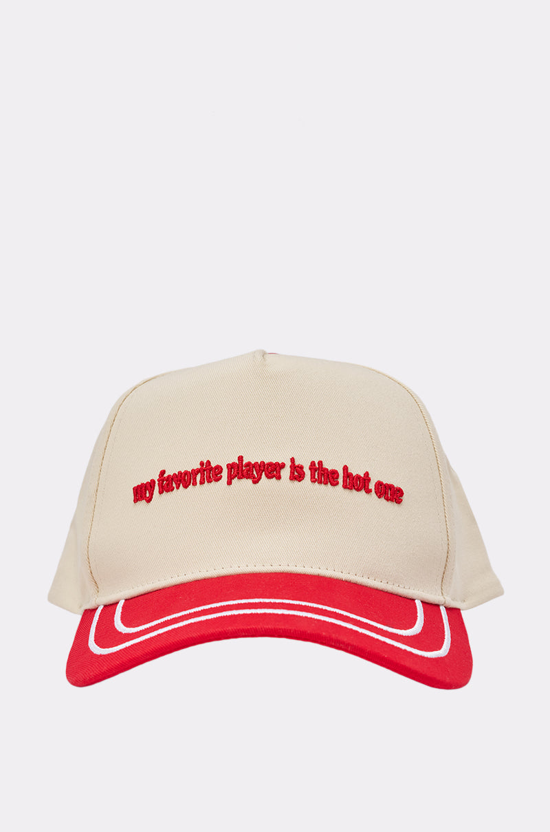 The DO YOU SEE THEM BASEBALL HAT is a beige adjustable snapback with a red brim and red front embroidery that says, "my favorite player is the hot one," offering both style and comfort.