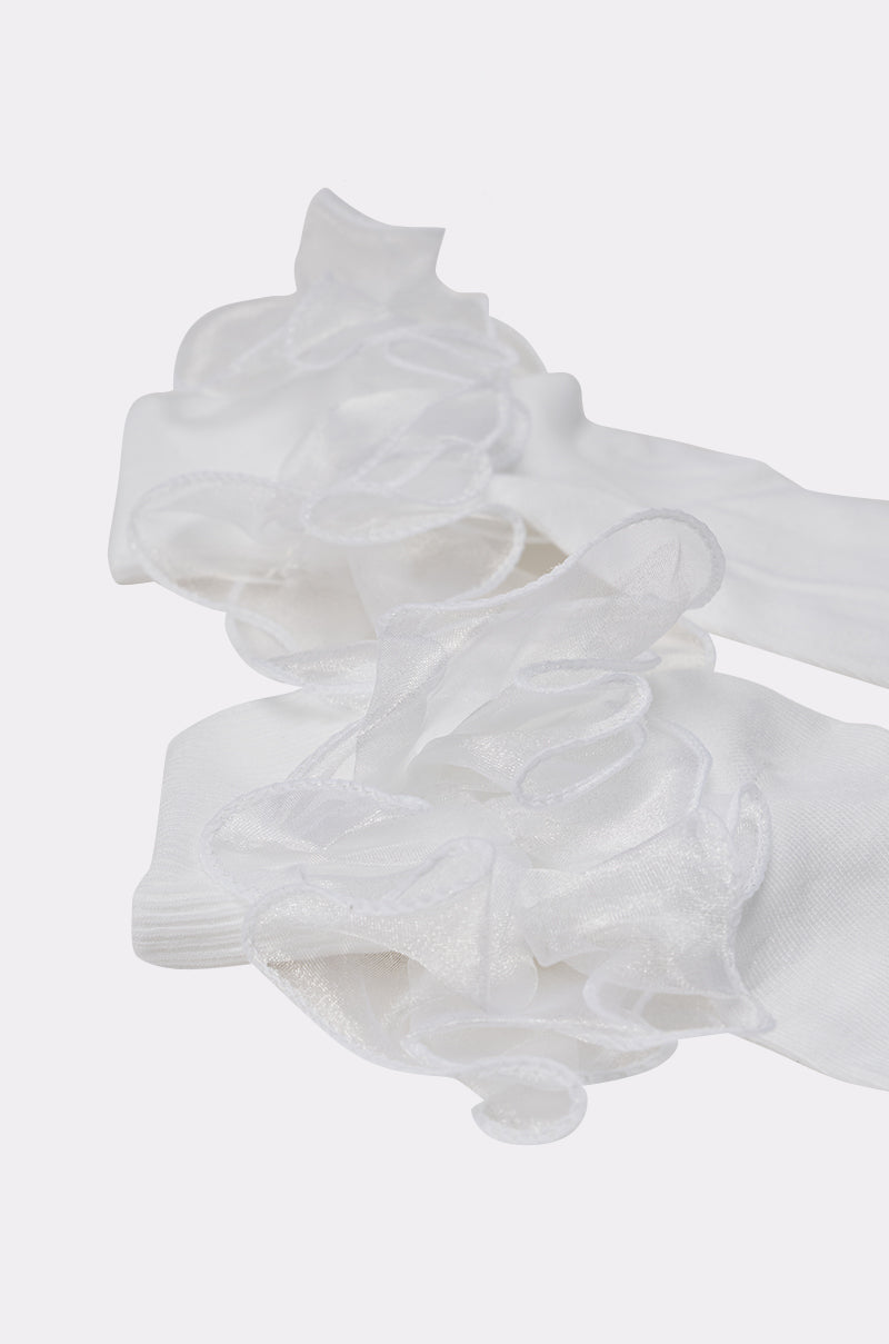 Close-up of RUFFLE ME UP SOCKS, organza ruffle socks with sheer, wavy-trimmed ruffles, laid on a light background—ideal for a coquette-inspired look. 4