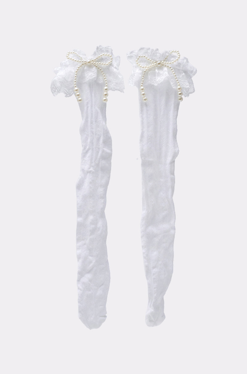 RUFFLE MANIA KNEE HIGH SOCKS feature a white lace open knit design, ruffle trim, and pearl-like bead bows. Displayed against a plain light background.