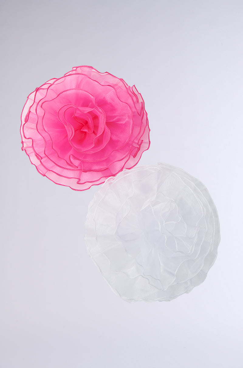 The TIS THE SEASON BROOCH SET features two organza fabric flowers on a light gray background: a pink top flower with ruffled edges and an intricately designed white bottom flower, both resembling oversized brooches with layered, petal-like structures for an avant-garde romantic look.