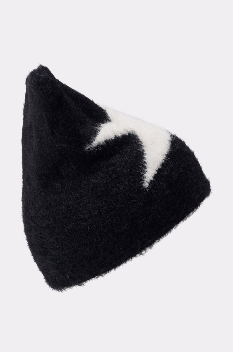 The IT GURL BEANIE is a black fuzzy knit beanie with a pointed top and a white lightning bolt design on the side, perfect for trendsetters and shown against a plain light gray background. 2